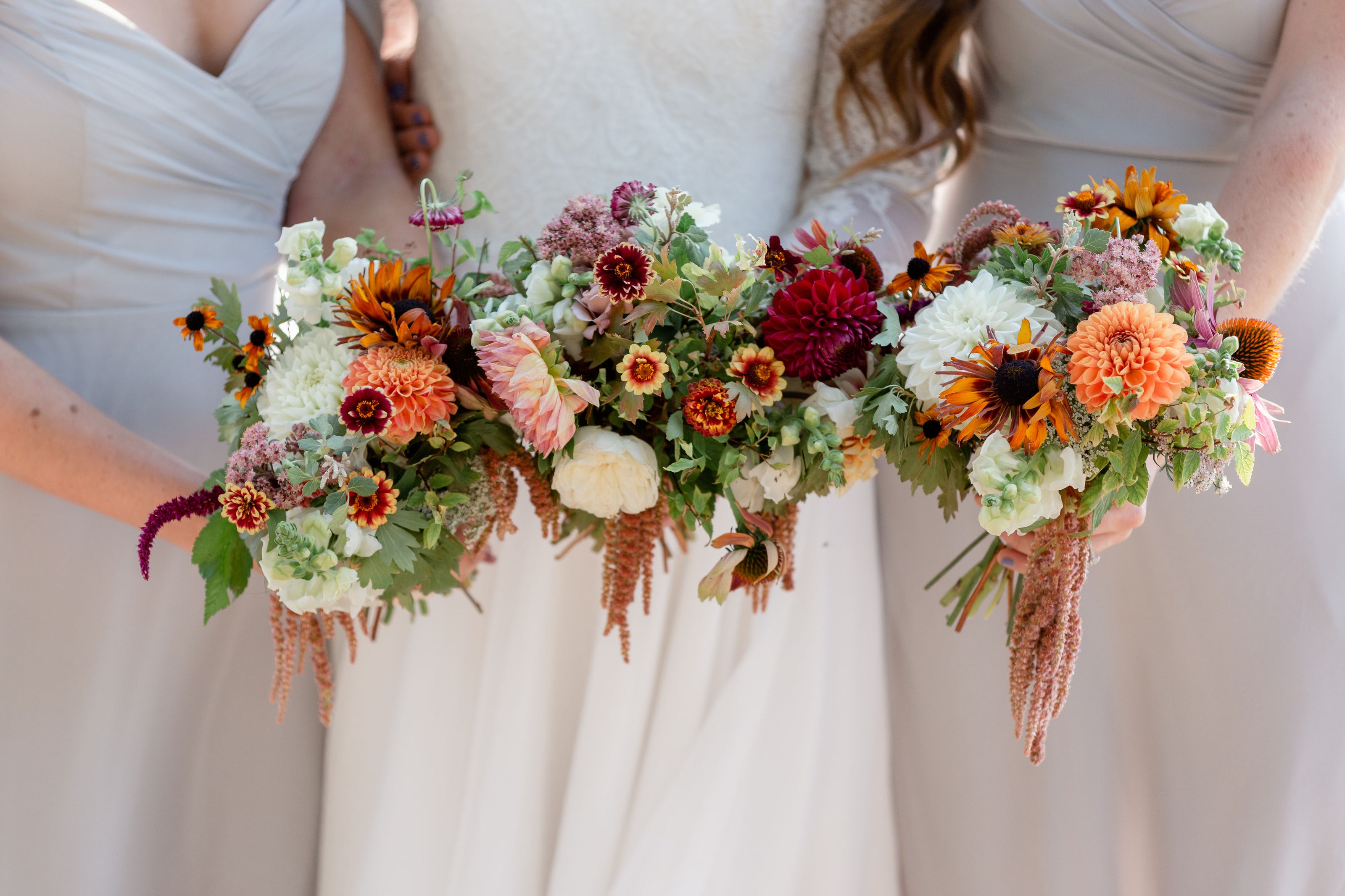 September bridal party flowers at Jackson Hole Wyoming wedding. Bouquets feature dahlias and zinnias. Dandelion Floral florist.